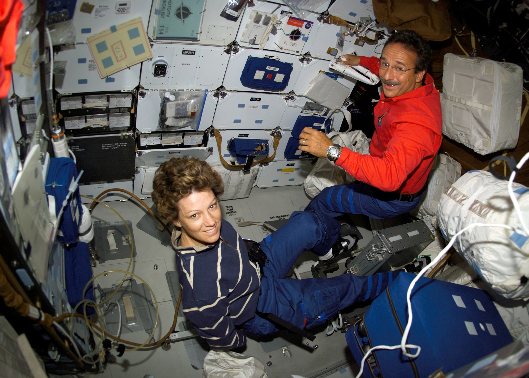 Mail and female sit in space shuttle 